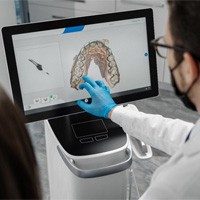 dentist and patient looking at 3D image on scanner screen