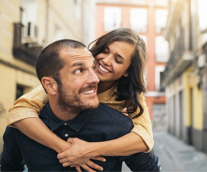 Man and woman smiling in Alley after visiting dentist in Arlington