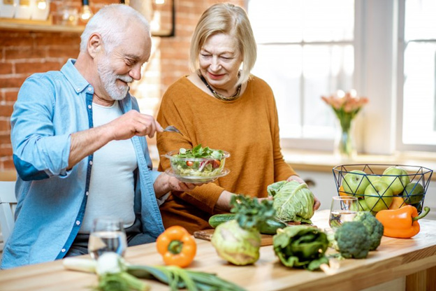 Couple preparing a salad in the kitchen