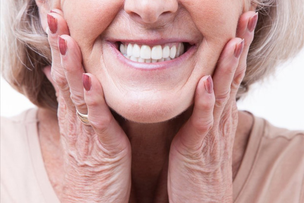 Woman smiling and touching her face