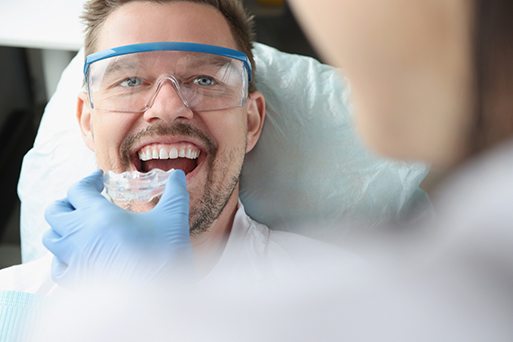 Arlington patient checking clear aligner progress at dentist