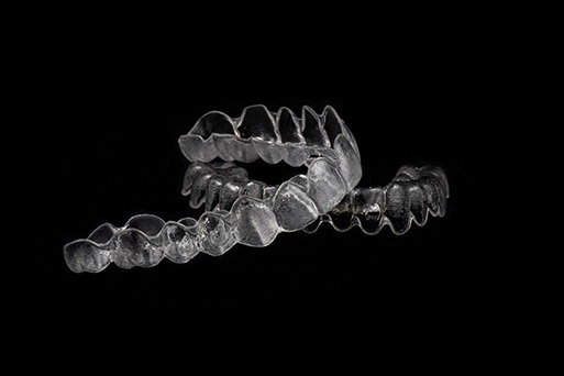 Close-up of clear aligners on black background