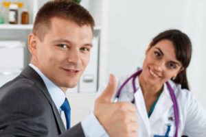 Man giving thumbs up at dental office