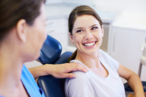 Woman in dental chair smiling at Arlington dentist