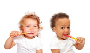 toddlers with toothbrushes