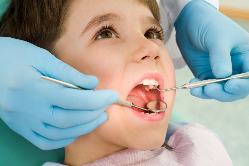 a young child in the dentist chair having his teeth checked