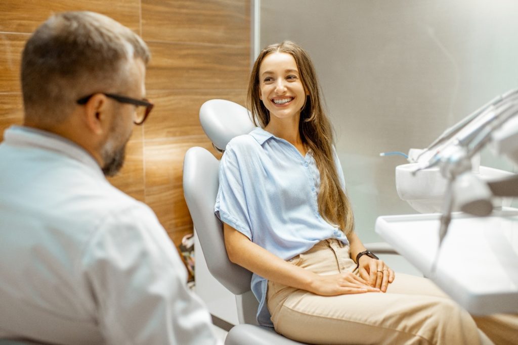 Woman smiling at dentist in treatment chair