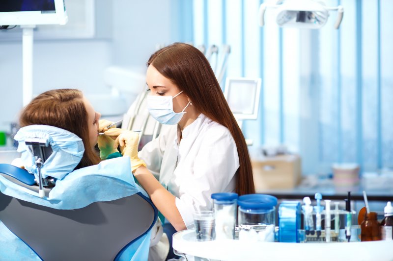 a dental hygienist working on a patient