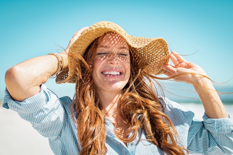 young woman smiling after getting cosmetic dentistry in Arlington