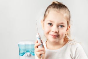 girl holding Waterpik 