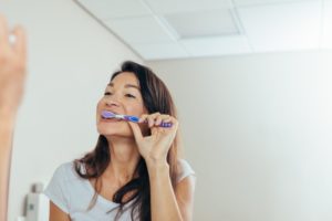 a woman brushing her teeth